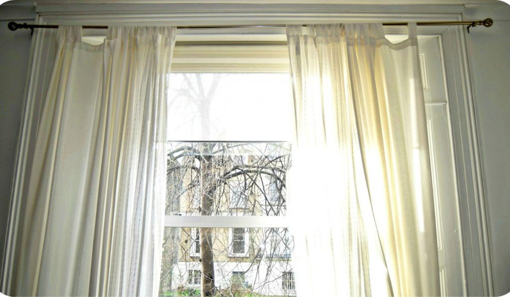 porch curtains are hanged around porch screens
