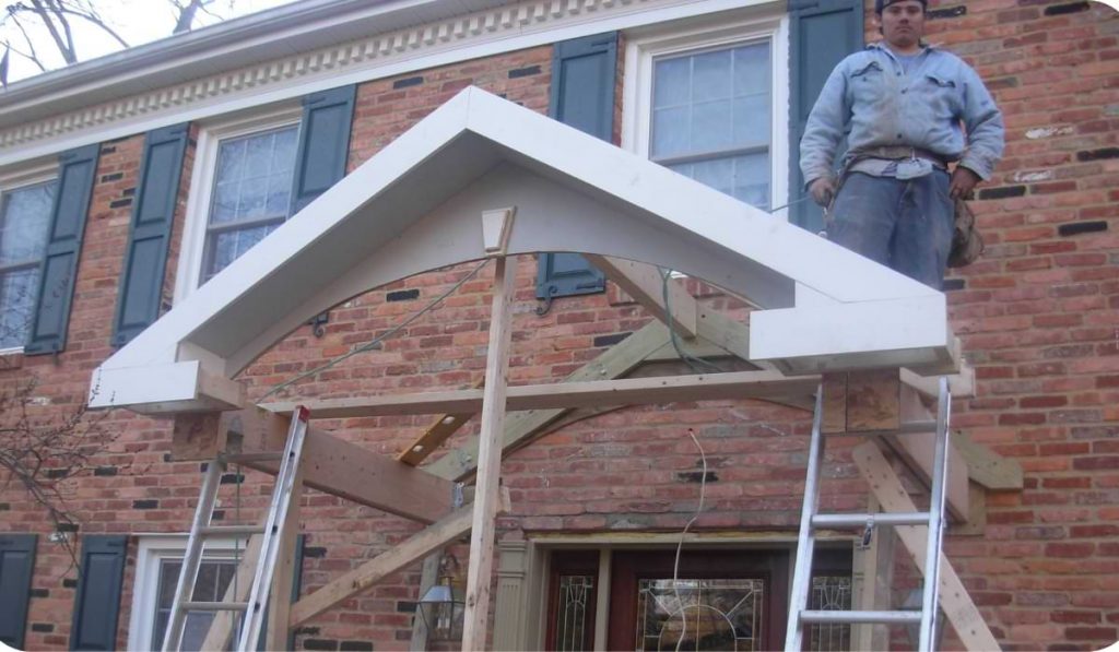 A man is Installing a porch roof