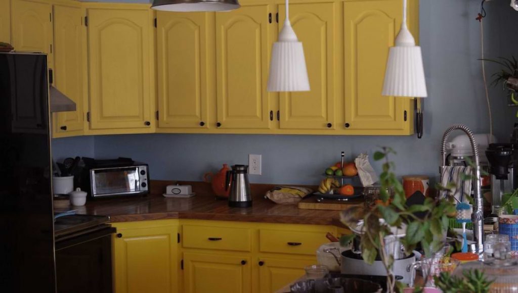 brown granite and yellow color cabinets